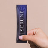 A hand holding a Serune Evening Ritual sachet