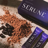 The Serune box and two sachets laid out with cacao powder and dried cherries