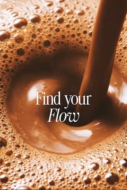 Chocolate poured into a frothy mug, with the words Find your Flow